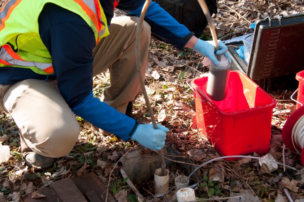 Appraiser taking water sample for phase 2 environmental site assessment