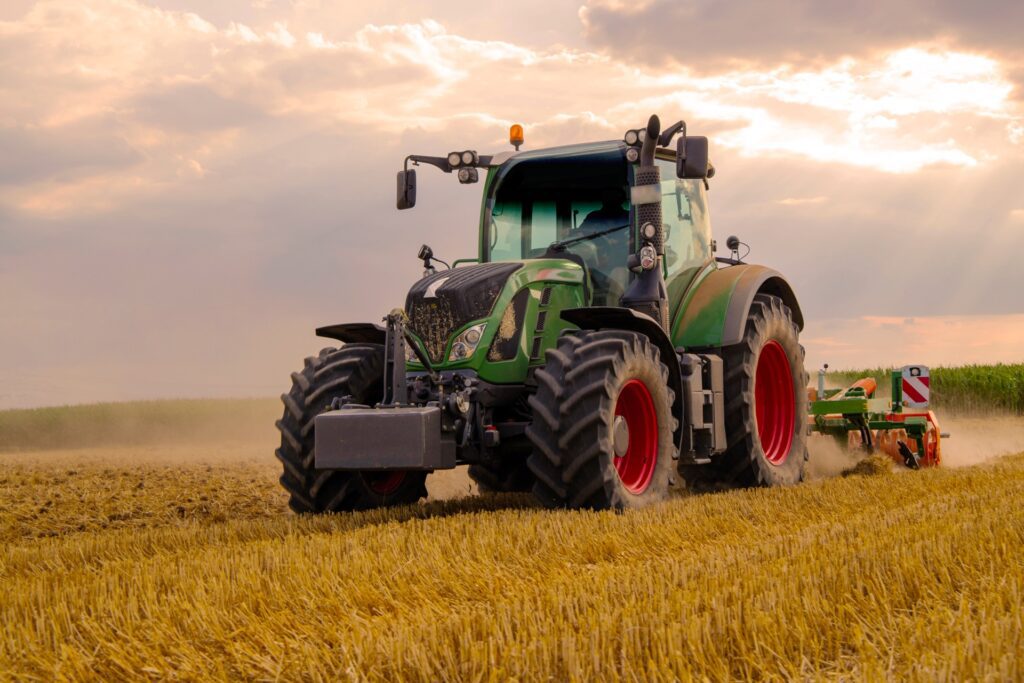 Tractor ploughing field after farmland appraisal